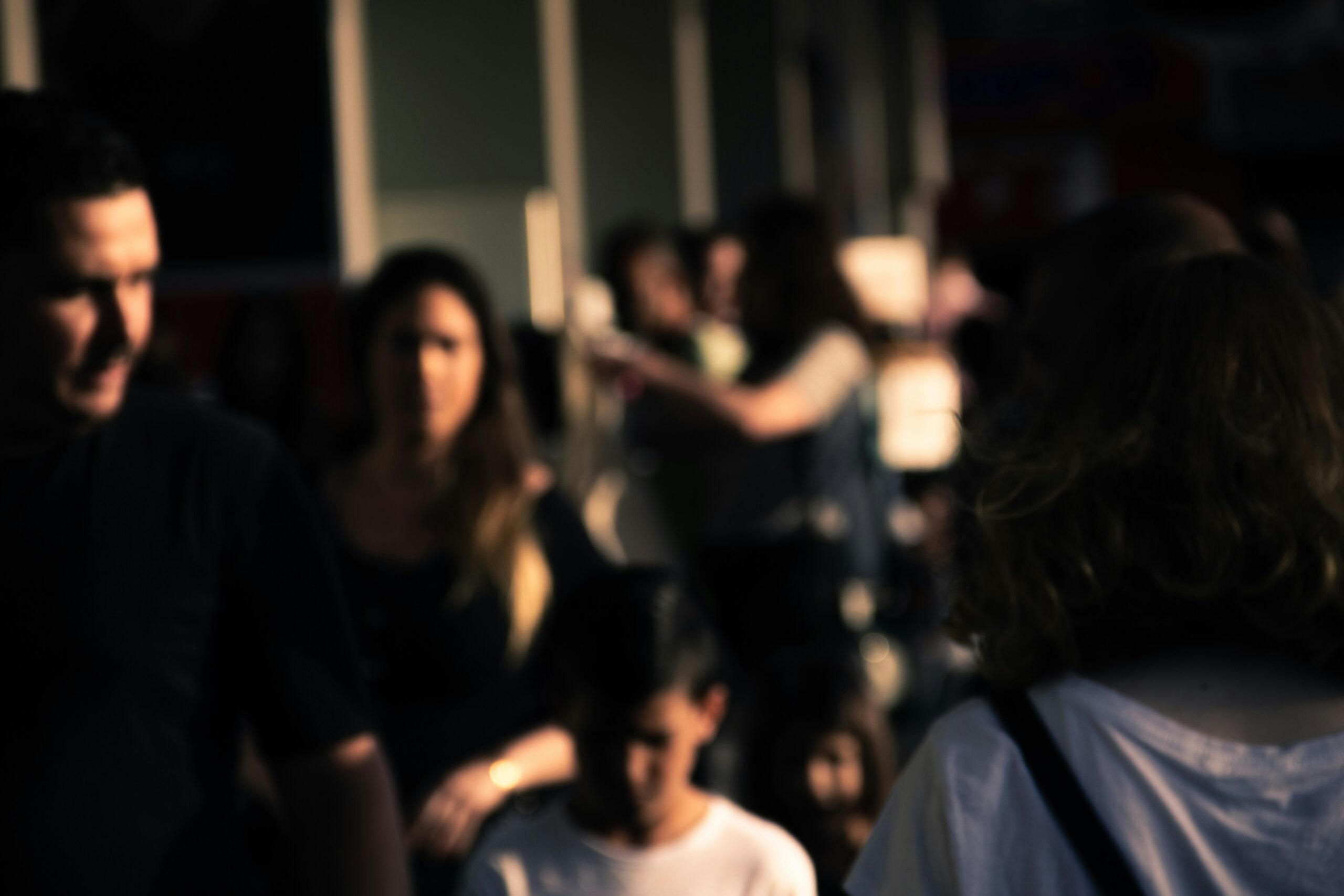 Person experiencing anxiety in a blurred crowd of people