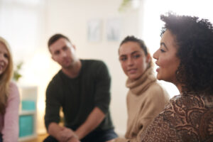 Woman Speaking At Support Group Meeting In Community Space