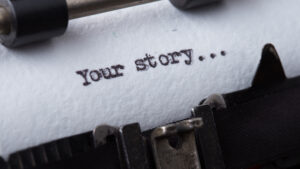close up of a piece of paper in a typewriter that says "your story..."