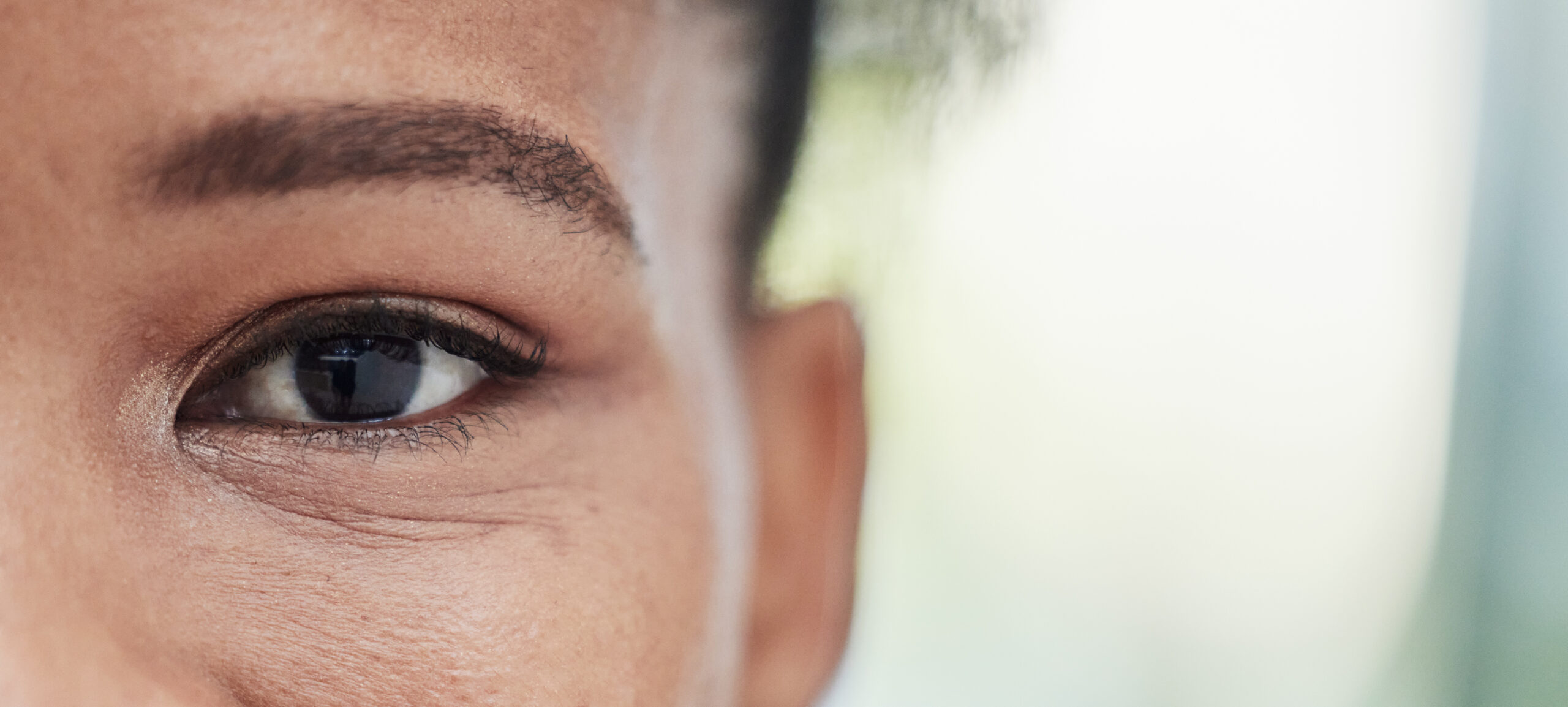 Close up of a woman's face focusing on eye. Demonstrating bilateral stimulation of EMDR therapy in Denver.