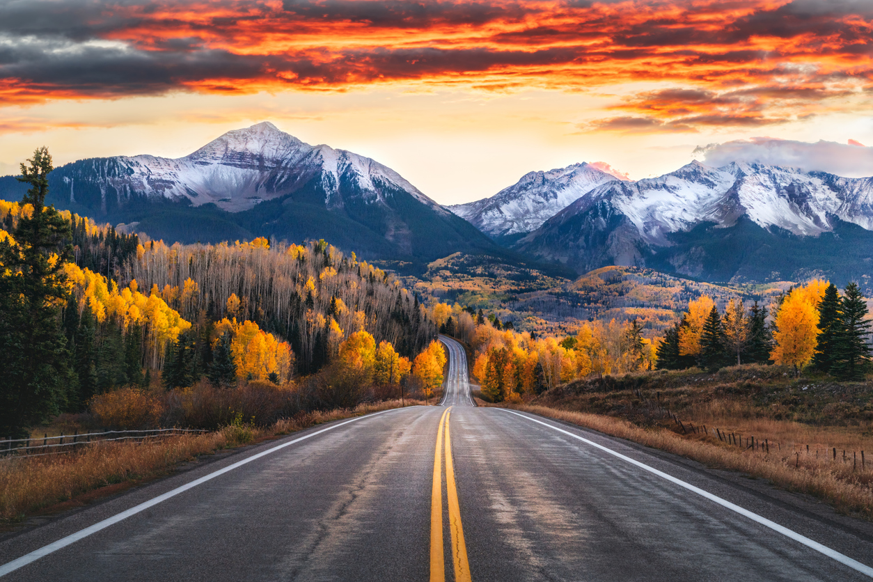 tunning sunset Sky Over Colorado Highway with San Juan Mountains in the distance, near Telluride. Symbolizing a road map back to self