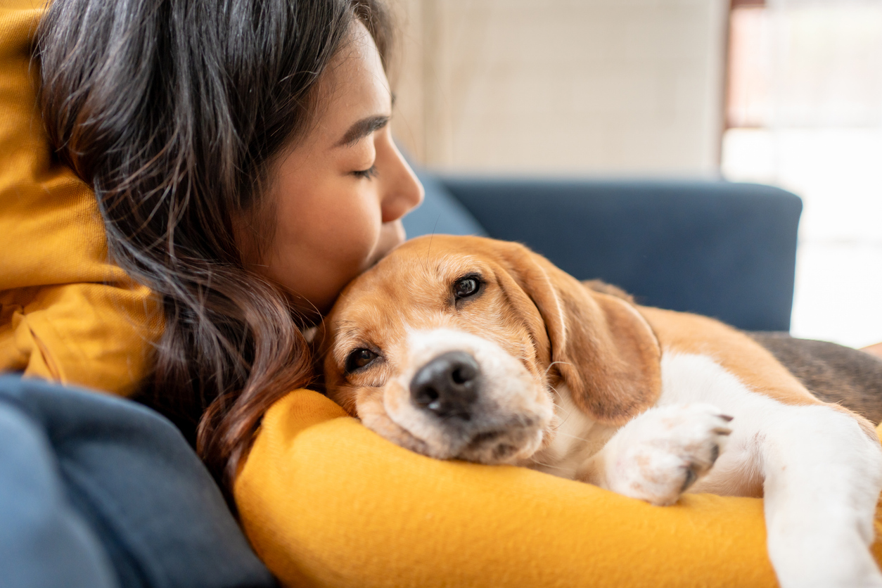 Woman resting while holding her dog - regulating her nervous system