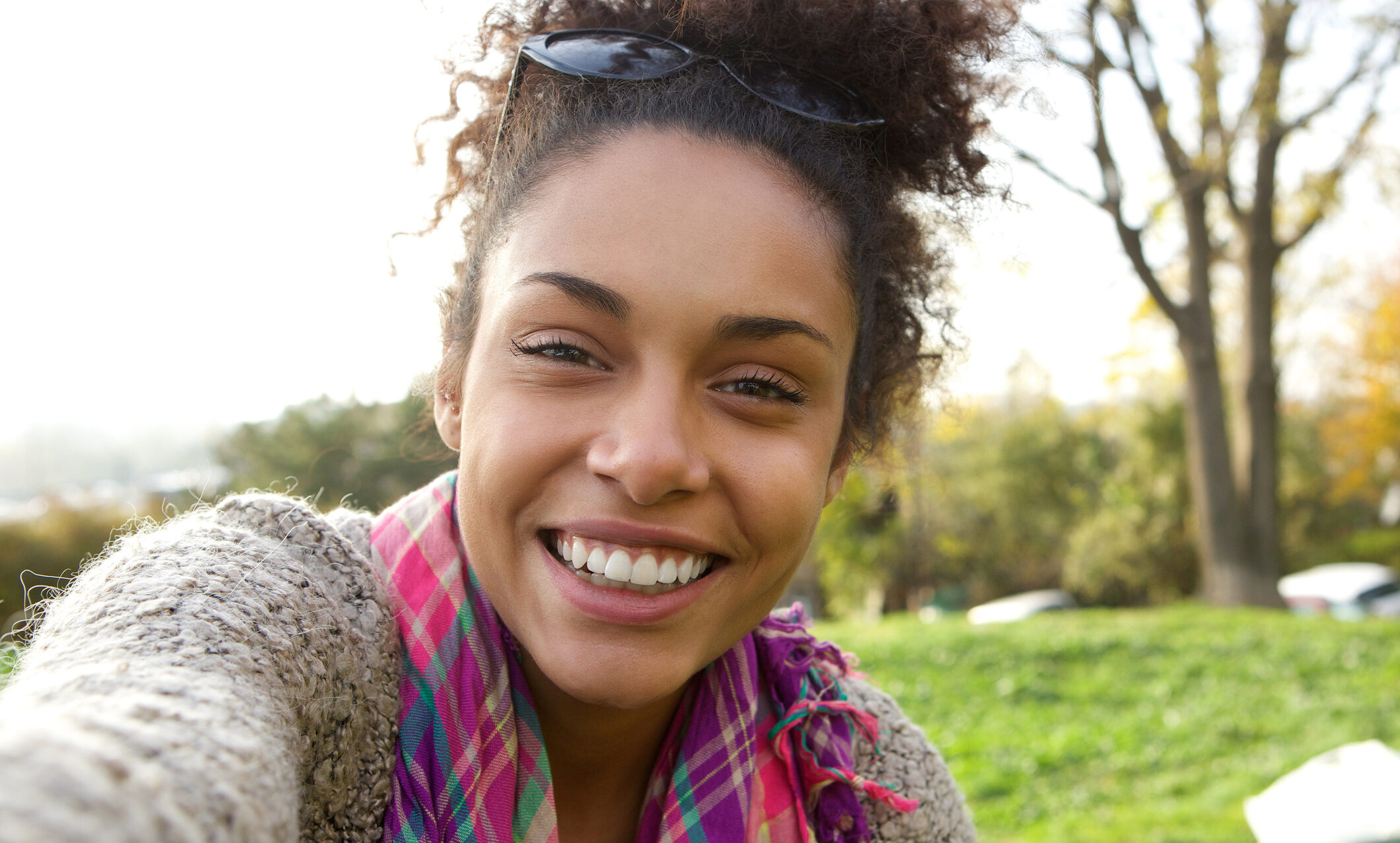 Selfie portrait of a smiling young Black woman happy to be outdoors