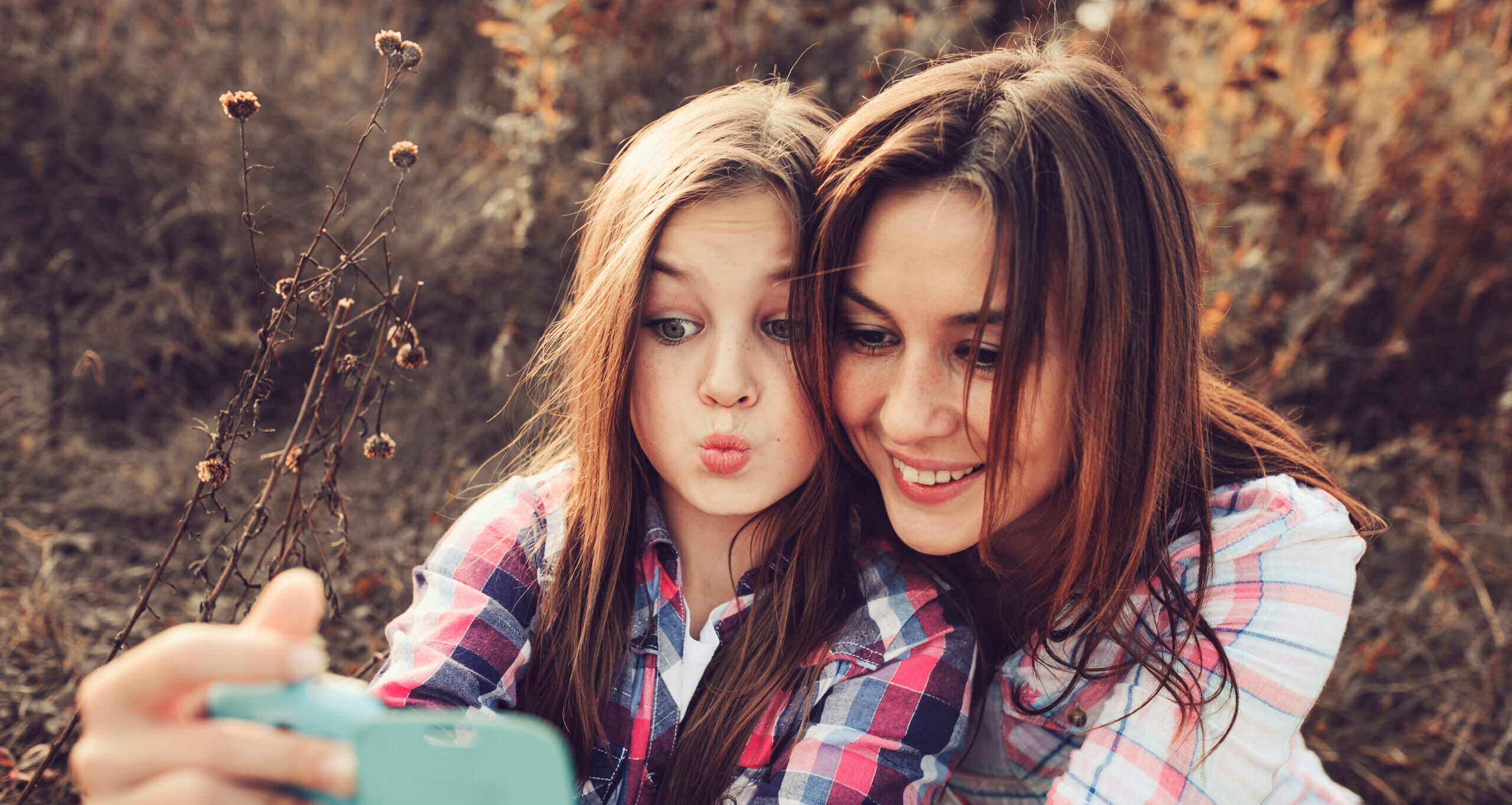 happy mother and daughter taking a selfie. Mom talking with teen daughter