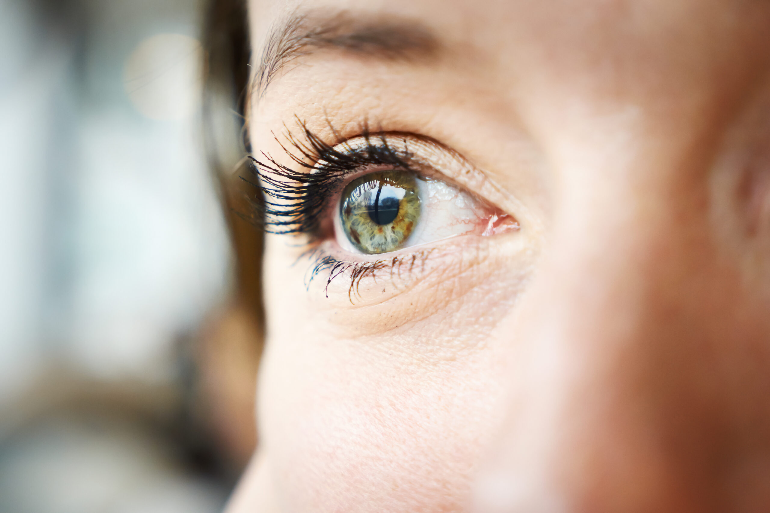 Close up of a person's face highlighting one green eye alluding to EMDR therapy