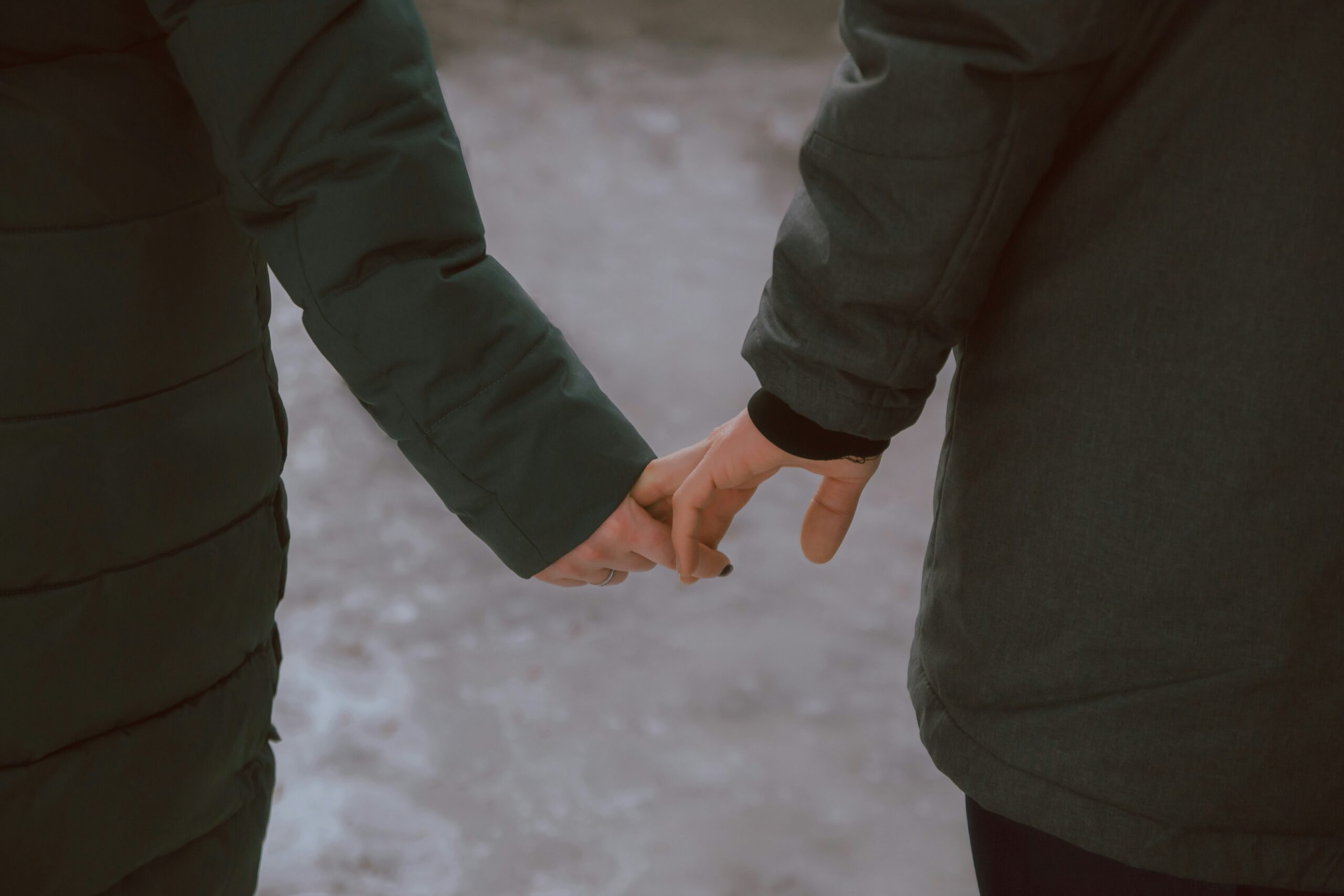 Two people holding hands, exploring their attachment styles in dating