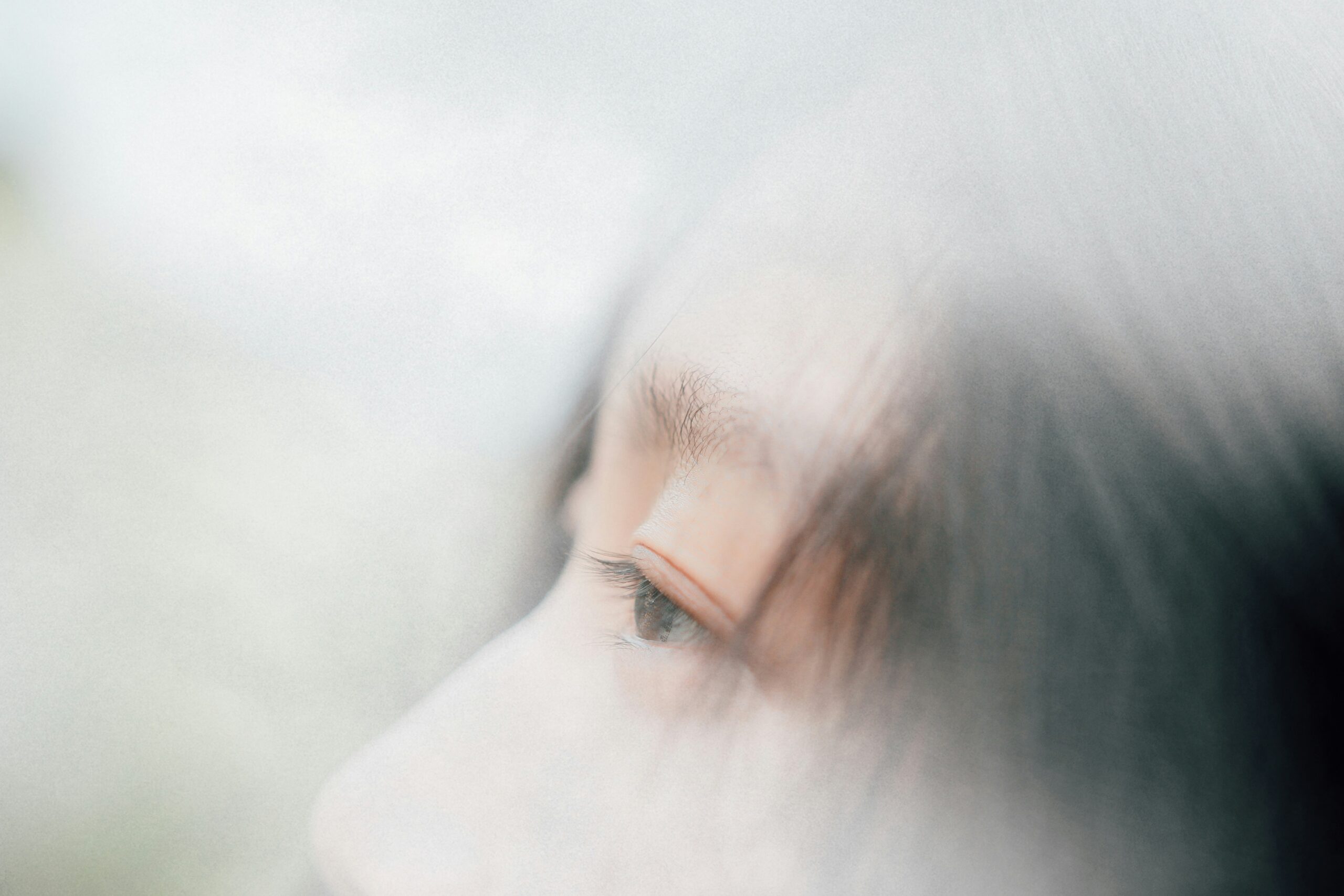 Profile of a person's face in fog dissociating after being triggered by something that happened