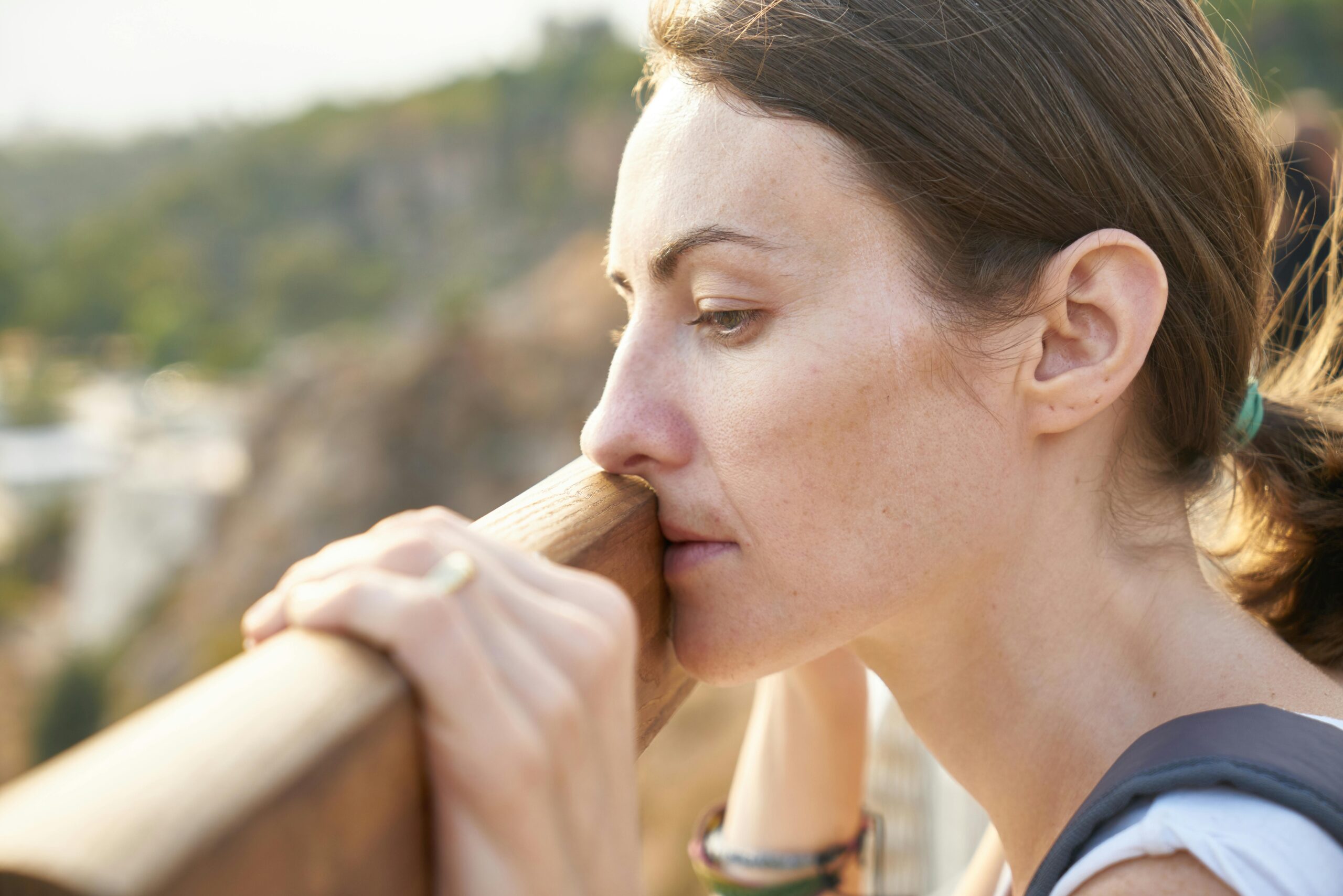 Woman looking out at nature wanting help working through generational trauma