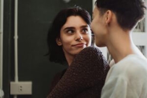 A couple looking at each other, exploring their relationship and attachment style