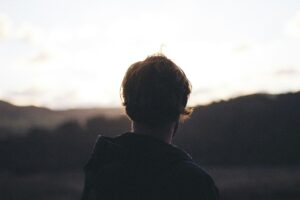 Person considering Ketamine therapy. Looking out over the silhouette of a field.
